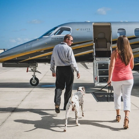 A couple walk towards a private jet in their way to a deserved vacation.