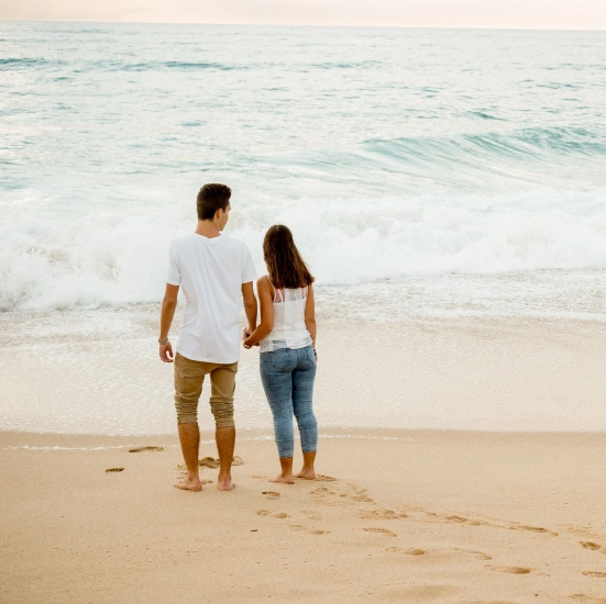 A relaxed couple enjoy the sunset on private island.